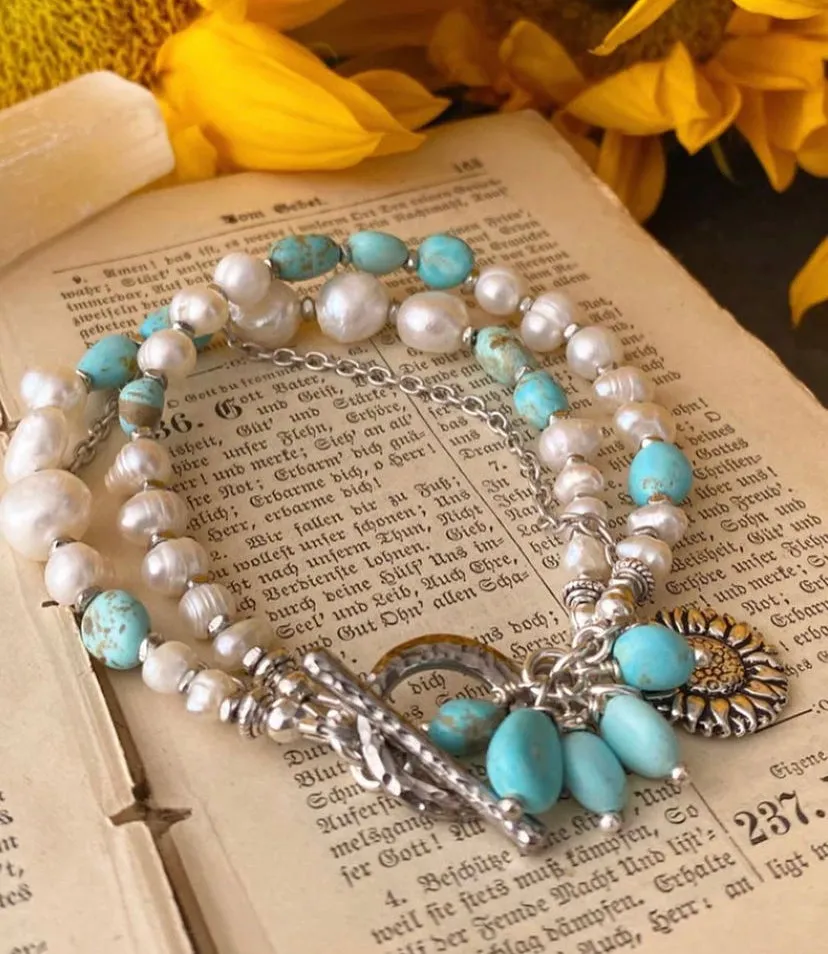 Turquoise stone, pearl, multi strands and silver metal bracelet.