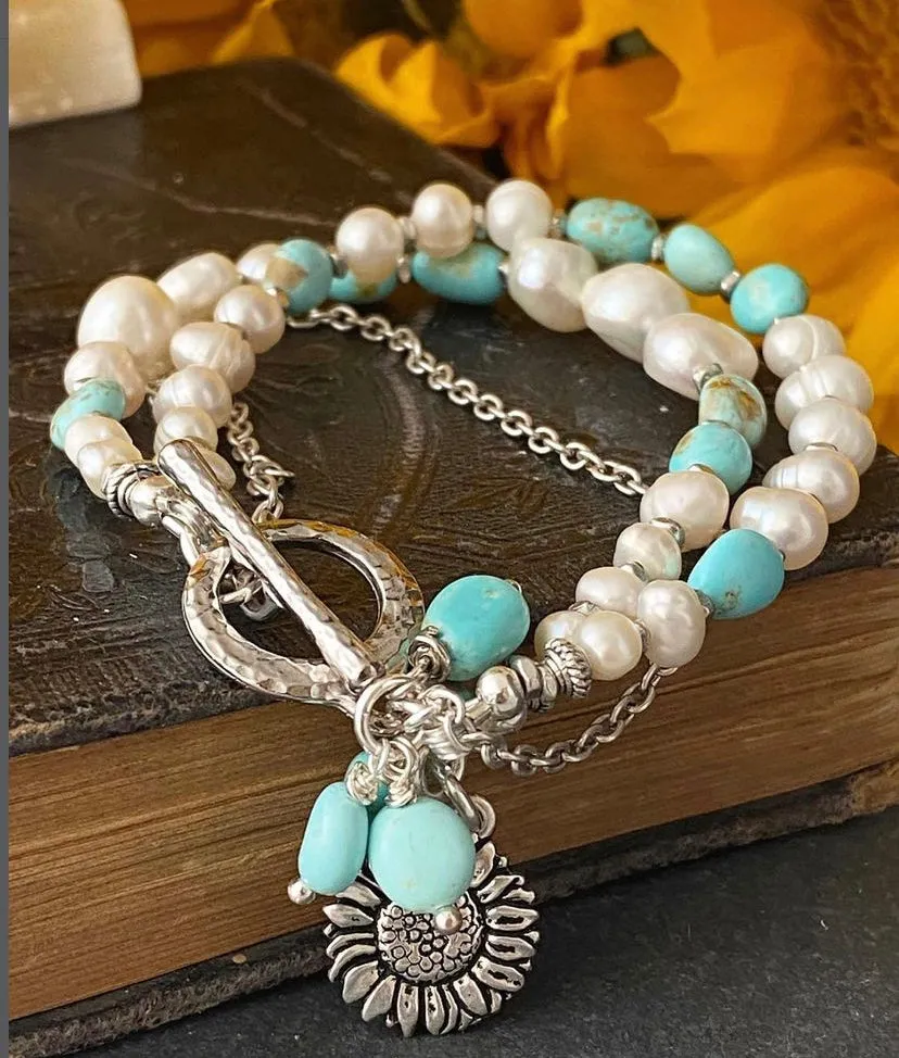 Turquoise stone, pearl, multi strands and silver metal bracelet.